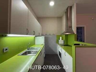 a kitchen with green and white counters and a sink at Palau de la música 3 in Barcelona