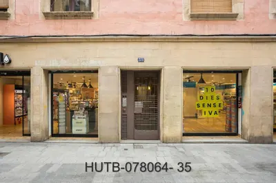 a store front with windows with signs in it at Palau de la música 4 in Barcelona