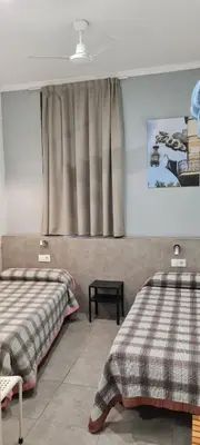 a bedroom with two beds and a window at Pensión 45 in Barcelona