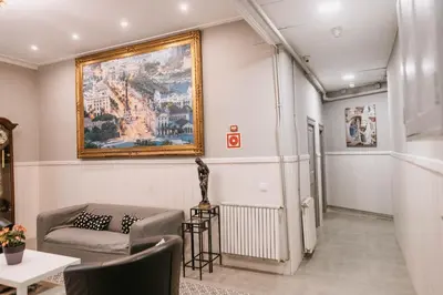 a living room with a couch and a painting on the wall at Pensión 45 in Barcelona