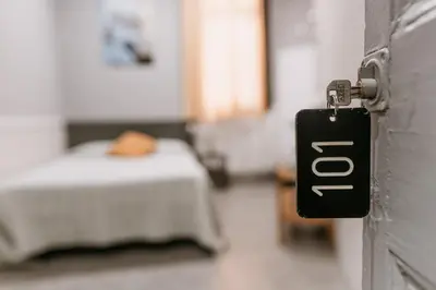 a door knob in a hospital room with a bed at Pensión 45 in Barcelona