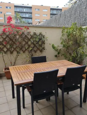 a wooden table and chairs on a roof at Stylish Duplex Loft with terrace in Barcelona