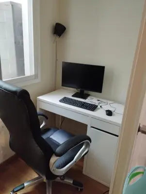 a desk with a computer monitor and a chair at Stylish Duplex Loft with terrace in Barcelona