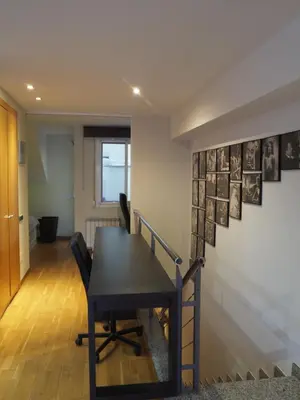 a dining room with a table and a staircase at Stylish Duplex Loft with terrace in Barcelona