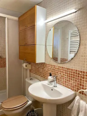 a bathroom with a sink and a toilet and a mirror at Villa Isabel Sitges, Rocamar in Sant Pere de Ribes