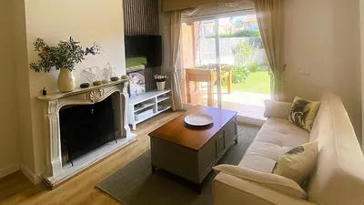 a living room with a couch and a fireplace at Villa Isabel Sitges, Rocamar in Sant Pere de Ribes