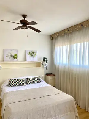 a bedroom with a bed and a ceiling fan at Villa Isabel Sitges, Rocamar in Sant Pere de Ribes
