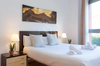 a living room with a television and a vase with a plant at Cosy Apartment next to Sagrada Familia V in Barcelona