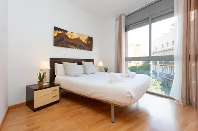 a living room with a couch with pillows and a table at Cosy Apartment next to Sagrada Familia V in Barcelona