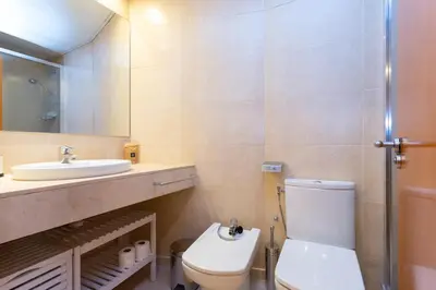 a bedroom with a white bed with a large window at Cosy Apartment next to Sagrada Familia V in Barcelona