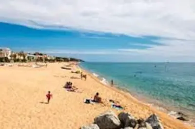 a group of people on a beach with the ocean at Apartment 3 minutes from the beach and train station on foot in Canet de Mar