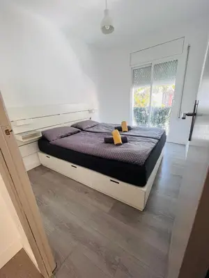 a large bed in a room with a window at Have Fun Apartment in Cubelles in Cubelles