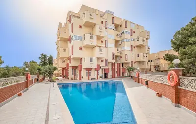 an apartment with a swimming pool in front of a building at Amazing Apartment In Sant Pere De Ribes in Sant Pere de Ribes