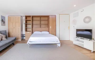a bedroom with a bed and a flat screen tv at Amazing Apartment In Sant Pere De Ribes in Sant Pere de Ribes