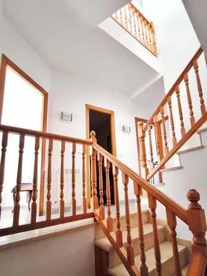 a winding staircase in a house with a skylight at Casa en alquiler vacacional Vilanova i la Geltrú in Vilanova i la Geltrú