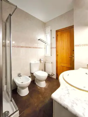 a bathroom with a toilet and a sink and a shower at Casa en alquiler vacacional Vilanova i la Geltrú in Vilanova i la Geltrú