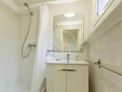 a white bathroom with a shower and a sink at Apartamento para 2 en Gracia in Barcelona