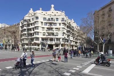 a group of people crossing a street in front of a building at Estudio en Barrio de Gracia E4 in Barcelona