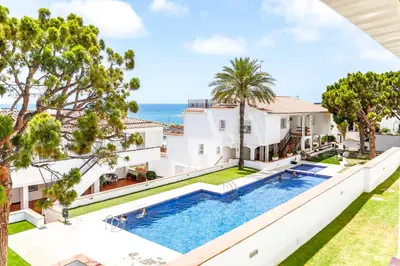 an aerial view of a house with a swimming pool and the ocean at Infinity Jupi Sea in Sitges