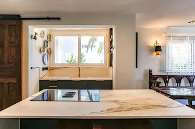 a kitchen with a counter top and a window at Infinity Jupi Sea in Sitges