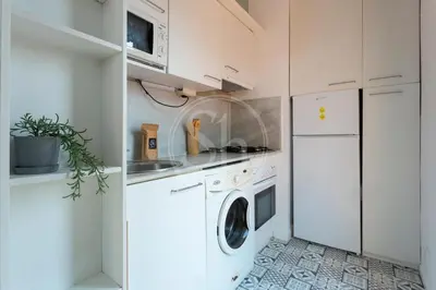 a bathroom with a toilet and a sink and a window at Cosy apartment with terrace in Barcelona
