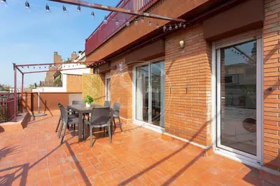 a patio with a table and chairs on a balcony at Cosy apartment with terrace in Barcelona