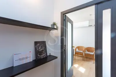 a door leading into a living room with a chair at Cosy apartment with terrace in Barcelona