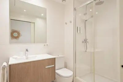 a bathroom with a shower and a toilet and a sink at Aspasios Arc de Triomf Apartments in Barcelona