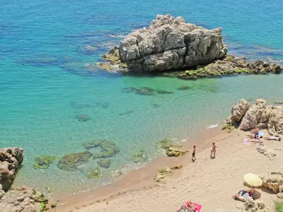 a group of people on a beach near the water at Casa Blanca in Sant Cebrià de Vallalta