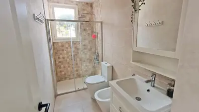 a bathroom with a shower and a toilet and a sink at Casa Blanca in Sant Cebrià de Vallalta