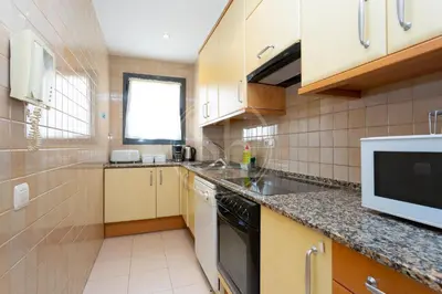 a kitchen with a sink and a microwave at Cómodo apartamento junto a Hospital Sant Pau in Barcelona