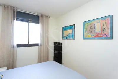 a bedroom with a bed and two pictures on the wall at Cómodo apartamento junto a Hospital Sant Pau in Barcelona