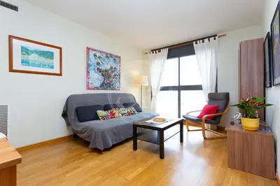 a living room with a couch and a table at Cómodo apartamento junto a Hospital Sant Pau in Barcelona