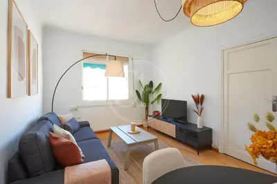 a living room with a blue couch and a table at Huge Sagrada Familia in Barcelona