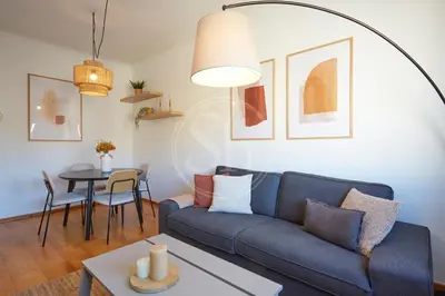 a living room with a blue couch and a table at Huge Sagrada Familia in Barcelona