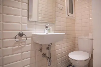 a bathroom with a sink and a toilet at BBarcelona Aragó Flat in Barcelona