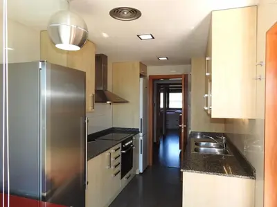 a kitchen with a stainless steel refrigerator and a sink at Piso en zona fòrum con vistas al mar in Barcelona