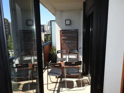 a balcony with chairs and a table on a building at Piso en zona fòrum con vistas al mar in Barcelona