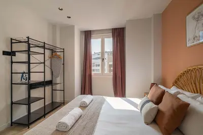 a bedroom with a large bed and a window at Stay U-nique Apartment Corsega II in Barcelona