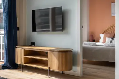 a room with a table next to a bed at Stay U-nique Apartment Corsega II in Barcelona