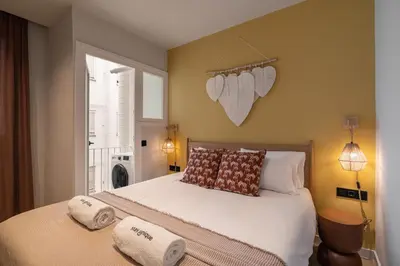 a bedroom with a bed with two pillows on it at Stay U-nique Apartment Corsega II in Barcelona