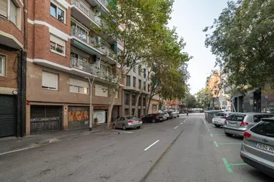 an empty city street with parked cars and buildings at Stay U-nique Apartment Corsega II in Barcelona