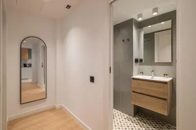 a bathroom with a sink and a mirror at Stay U-nique Apartment Corsega II in Barcelona