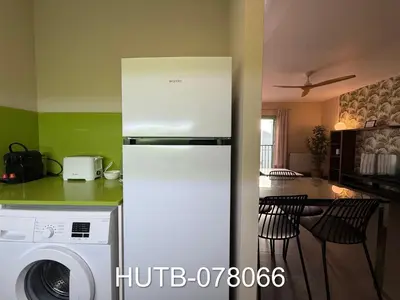 a white refrigerator in a kitchen with a washer at Palau de la música 6 in Barcelona