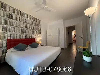 a bedroom with a large white bed with a red headboard at Palau de la música 6 in Barcelona