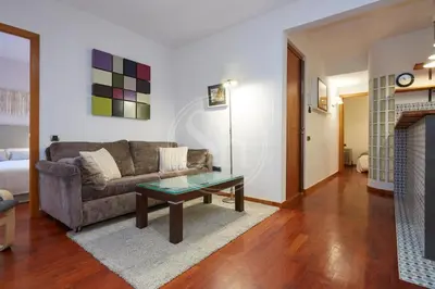 a living room with a couch and a coffee table at Nice apartment in Les Corts in Barcelona