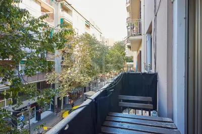 a wooden bench sitting on the side of a building at Nice apartment in Les Corts in Barcelona