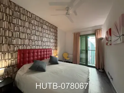 a bedroom with a large bed with a red headboard at Palau de la música 7 in Barcelona