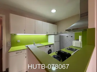 a green and white kitchen with a sink and a dishwasher at Palau de la música 7 in Barcelona