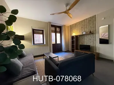 a living room with a couch and a tv at Palau de la música 8 in Barcelona